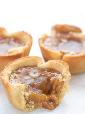 A keto butter tart broken open with the filling oozing out.