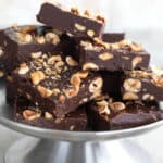 Sugar Free Hazelnut Fudge piled up on a metal cake stand.