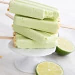 A stack of Key Lime Protein Popsicles on a white cupcake stand.