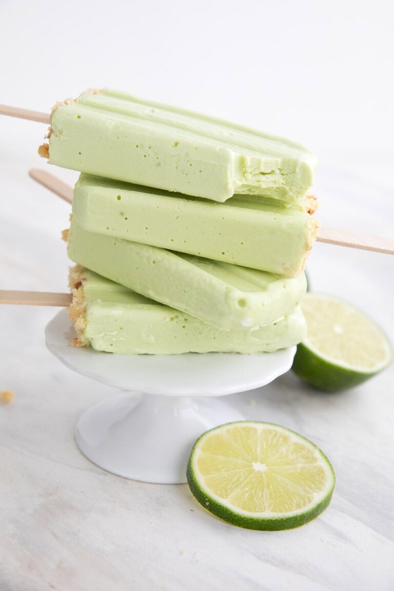 A stack of Key Lime Protein Popsicles on a white cupcake stand.