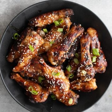 Top down image of a black bowl filled with Keto Teriyaki Chicken Wings.