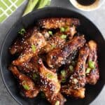 Top down image of a black bowl filled with keto teriyaki wings.