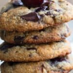 Titled Pinterest image of a stack of keto cherry chocolate chunk cookies with a fresh cherry on top.