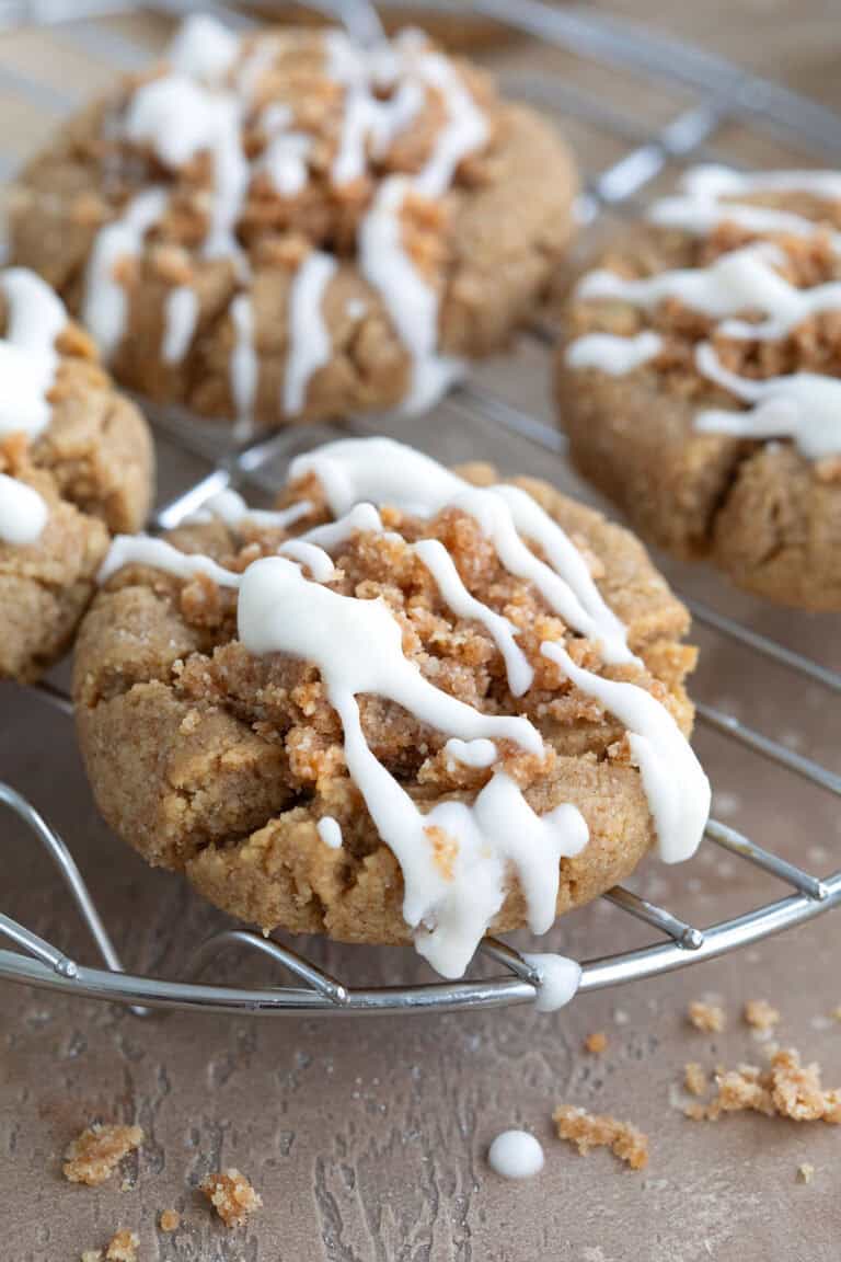 Keto Coffee Cake Cookies cooling on a wire rack over a brown concrete table.