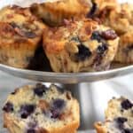 Keto granola muffins on a metal cake plate with one broken open to show the inside.