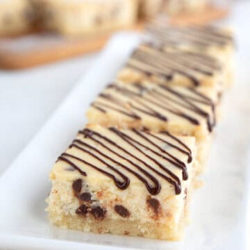 Keto Cannoli Cheesecake Bars lined up on a small white tray.