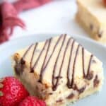 Titled Pinterest image of a protein cheesecake bar on a gray plate with fresh berries.