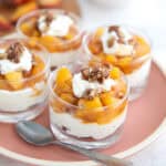 Four Easy Keto Peach Cheesecakes on a pink plate.