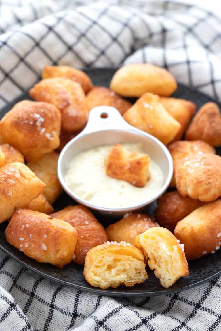 Keto Pretzel Bites on a black plate over a checked napkin.