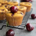 Keto Cherry Chocolate Chip Muffins cooling on a wire baking rack.