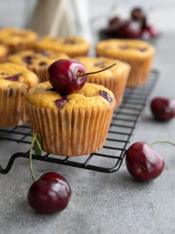 Keto Cherry Chocolate Chip Muffins cooling on a wire baking rack.