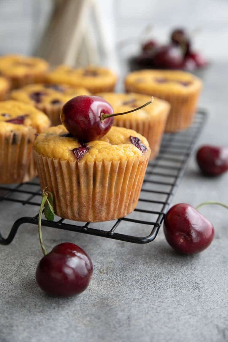 Keto Cherry Chocolate Chip Muffins cooling on a wire baking rack.