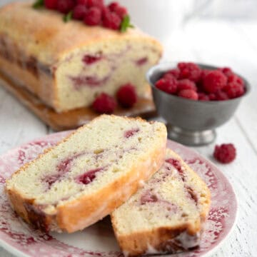 Two slices of Keto Raspberry Swirl Bread on a red patterned plate.