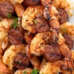 Titled Pinterest image of Shrimp and Sausage Skewers on a white platter.