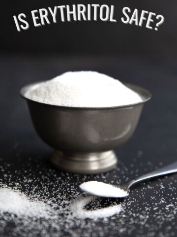 A bowl of granular sweetener on a black background with the title Is Erythritol Safe across the top.