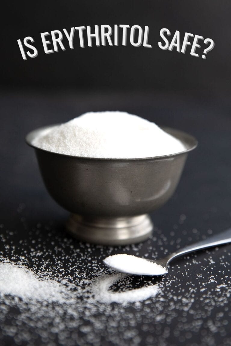 A bowl of granular sweetener on a black background with the title Is Erythritol Safe across the top.