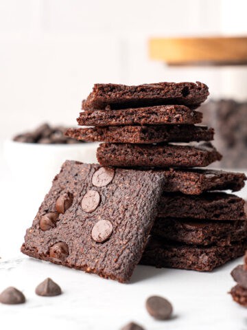 Close up shot of a stack of Keto Brownie Bark on a marble tabletop.