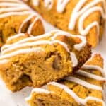 Keto Pumpkin Scones on a wire cooling rack with one of them broken open.