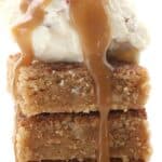 Titled image of a stack of Keto Snickerdoodle Blondies with ice cream and caramel sauce on top.