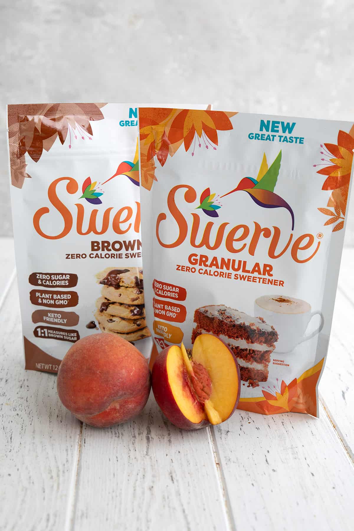 Two bags of Swerve Sweetener on a white table with a cut up peach in front.