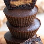 A stack of Air Fryer brownies stuffed with peanut butter cups, with one cut open to show the inside.