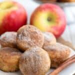 Titled image of Keto Apple Cider Donut Bites on a white plate with a cinnamon stick.