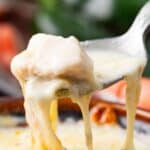 Titled Pinterest image of a spoon lifting Chile Relleno Soup out of a brown bowl.