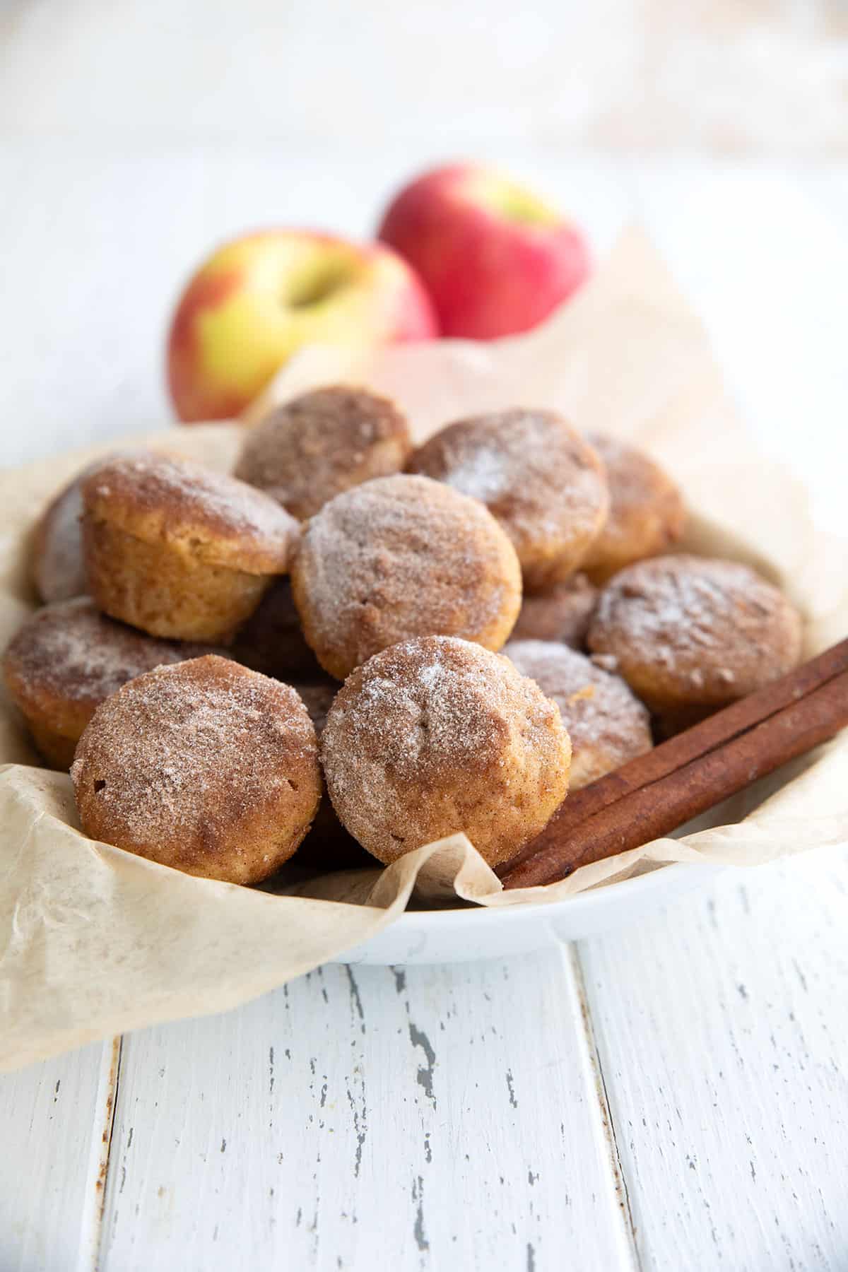 A white bowl filled with Keto Apple Cider Donut Bites.