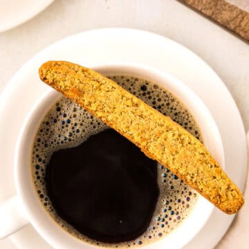 Top down image of a Keto Pumpkin Biscotto resting on top of a cup of coffee.