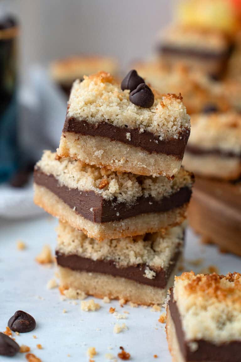 Close up shot of a stack of Keto Fudge Crumb Bars on a white table.