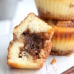 Keto Cinnamon protein muffin cut open on a white table to show the inside.