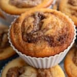 Titled image of Keto Cinnamon Roll Protein Muffins in a stack on a baking rack.