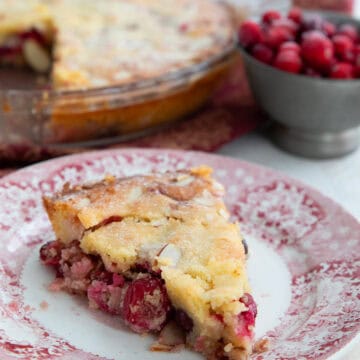 A slice of keto cranberry pie on a red patterned plate.