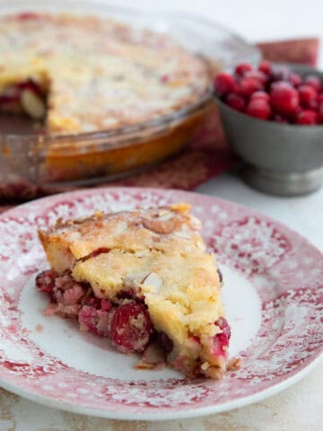 A slice of keto cranberry pie on a red patterned plate.