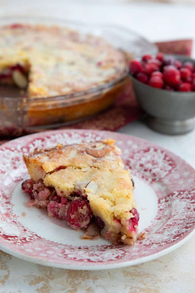 A slice of keto cranberry pie on a red patterned plate.