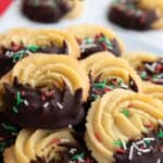 Titles image of Keto Danish Butter Cookies piled up on a white plate.