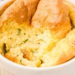 Titled image close up of a Keto Cheese Soufflé with a forkful taken out of it.