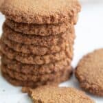 Titled Pinterest image of Keto Gingersnap Cookies with one broken in front.