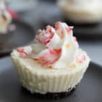 Close up shot of a Keto White Chocolate Peppermint Cheesecake on a gray plate.