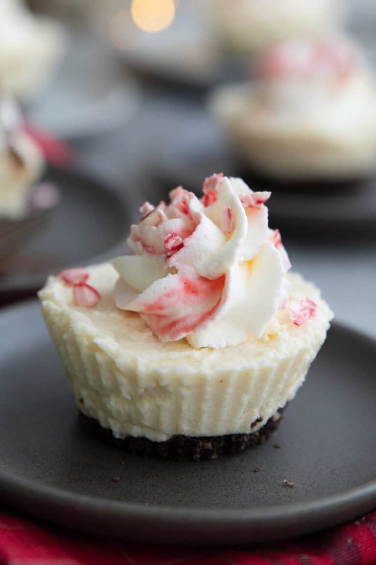 Close up shot of a Keto White Chocolate Peppermint Cheesecake on a gray plate.