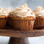 Keto Spice Cake Cupcake on a wooden cake stand.