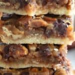 Titled image close up of a stack of Keto Pecan Pie Bars.