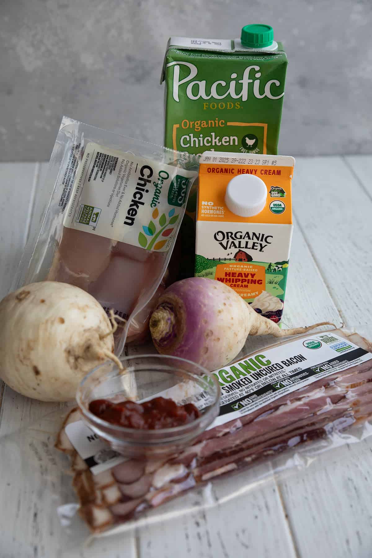 Some of the ingredients for Keto Chicken Chowder on a white table.