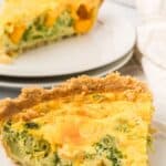 A slice of Broccoli Cheese Keto Quiche on a white plate.