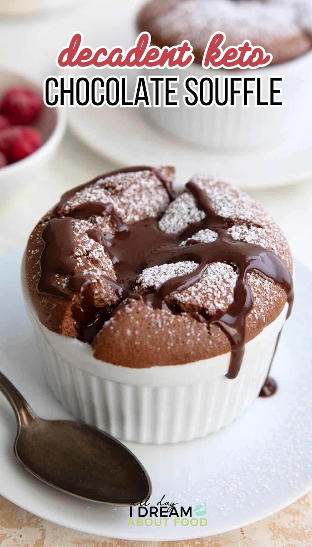 Titled image of a Keto Chocolate Soufflé in a white ramekin with powdered sweetener and chocolate sauce drizzled overtop.