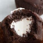 Titled Pinterest image close up of a Keto Hostess Cupcake with a bite taken out of it.