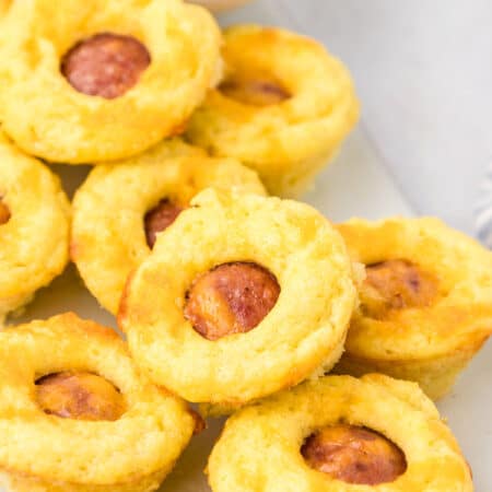 Close up shot of Mini Keto Corn Dogs on a white plate.