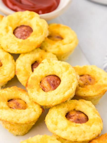 Close up shot of Mini Keto Corn Dogs on a white plate.