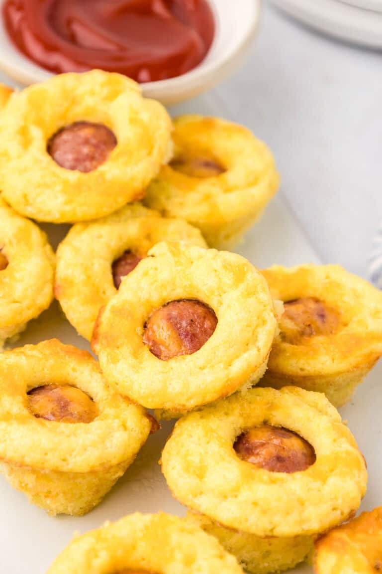 Close up shot of Mini Keto Corn Dogs on a white plate.