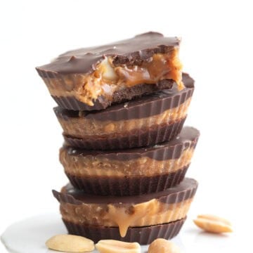 A stack of Keto Snickers Cups with a bite taken out of the top one.